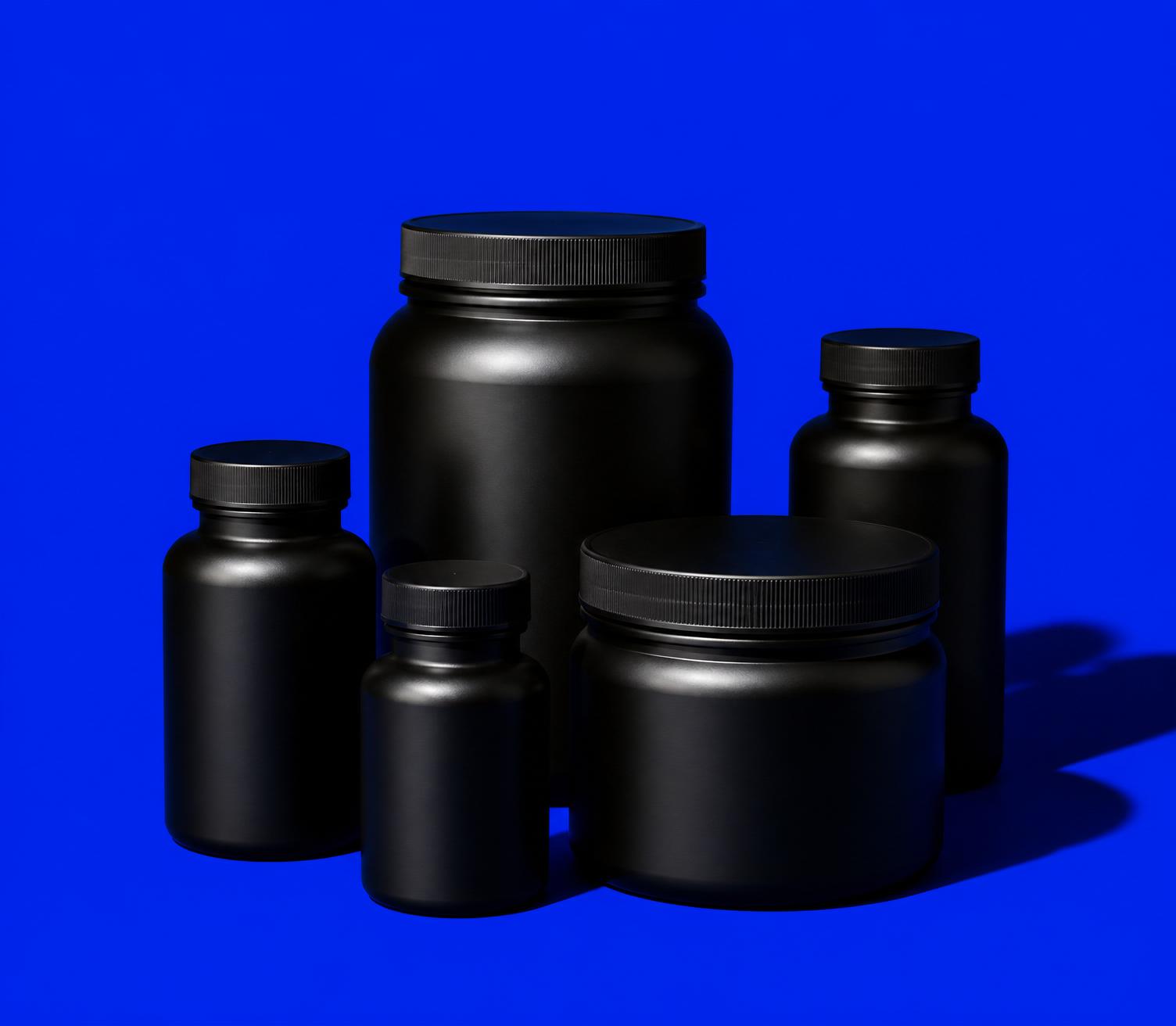Matte black supplement bottles on an electric blue background